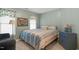 Light-filled bedroom with blue walls, striped bedding, carpet, and ample natural light at 10415 Ashmead Ln, Raleigh, NC 27614