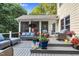 Relaxing deck area with cozy seating and views of screened-in porch and landscaped yard at 10415 Ashmead Ln, Raleigh, NC 27614