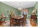 Elegant dining room featuring a wooden table with seating for six and a chandelier at 10415 Ashmead Ln, Raleigh, NC 27614