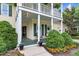 Inviting front porch with chairs, landscaping, and charming columns at 10415 Ashmead Ln, Raleigh, NC 27614