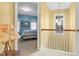 Bright hallway with yellow walls leads to a blue bedroom with blue accents and a carpeted floor at 10415 Ashmead Ln, Raleigh, NC 27614