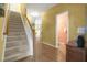 Hallway with staircase and view of powder room at 10415 Ashmead Ln, Raleigh, NC 27614