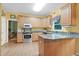 Well-lit kitchen with stainless steel appliances, and a breakfast bar at 10415 Ashmead Ln, Raleigh, NC 27614