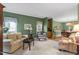 Cozy living room with traditional furnishings, hardwood floors and large windows at 10415 Ashmead Ln, Raleigh, NC 27614