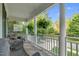 Covered porch with wicker seating and view of the street at 10415 Ashmead Ln, Raleigh, NC 27614
