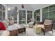 Bright sunroom featuring lots of windows, comfortable seating, and tiled flooring at 10415 Ashmead Ln, Raleigh, NC 27614