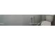 This is a close up image of a white toilet with a gray wall and metal grab bar at 1062 Beacon Hill Rd # 45, Lillington, NC 27546