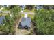 Aerial view of a home featuring a backyard deck, a neatly maintained yard, and surrounding trees for privacy at 108 Rocking Horse Ln, Sanford, NC 27332