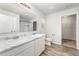 Well-lit bathroom featuring double sinks, a large mirror, a toilet, and shower with a sliding glass door at 108 Rocking Horse Ln, Sanford, NC 27332