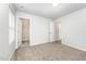 Comfortable bedroom with neutral walls, plush carpeting, and an open door to a large closet for storage at 108 Rocking Horse Ln, Sanford, NC 27332