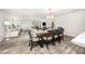 Open dining area featuring modern chandelier lighting and views into a comfy living room, ideal for seamless entertaining at 108 Rocking Horse Ln, Sanford, NC 27332