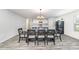 Bright dining room showcasing a wooden table with seating for six, alongside an open kitchen at 108 Rocking Horse Ln, Sanford, NC 27332