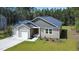 This single-story home features a two-car garage, neat landscaping, and a cozy front porch, perfect for relaxation at 108 Rocking Horse Ln, Sanford, NC 27332