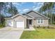 Charming home featuring a well-manicured front yard, a two-car garage, and a welcoming front entrance at 108 Rocking Horse Ln, Sanford, NC 27332