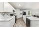 This modern kitchen is equipped with white cabinets, marble countertops, and sleek appliances, offering ample counter space at 108 Rocking Horse Ln, Sanford, NC 27332