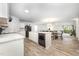 Bright, open kitchen featuring white cabinets, a central island with a sink, and modern appliances overlooking the living area at 108 Rocking Horse Ln, Sanford, NC 27332
