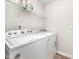 Laundry room featuring modern washing and drying machines with shelf above at 108 Rocking Horse Ln, Sanford, NC 27332