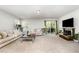 Bright living room with cozy couches, fireplace, and sliding glass doors to outdoor space at 108 Rocking Horse Ln, Sanford, NC 27332