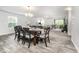 Open-concept living and dining areas with wood floors and a sliding glass door to outside at 108 Rocking Horse Ln, Sanford, NC 27332