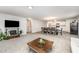 Cozy living room with a rustic fireplace, open to the kitchen and dining area, creating a welcoming and inclusive atmosphere at 108 Rocking Horse Ln, Sanford, NC 27332