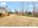 Expansive backyard features freshly laid straw, offering ample space for outdoor activities and potential landscaping projects at 1119 Brookfield Dr, Gibsonville, NC 27249