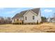 Exterior view of home featuring a neat landscape, complemented by a wooden deck perfect for outdoor living and enjoyment at 1119 Brookfield Dr, Gibsonville, NC 27249