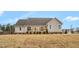 A cozy wooden deck is visible in the backyard, offering a perfect spot to unwind and enjoy the peaceful outdoor setting at 1119 Brookfield Dr, Gibsonville, NC 27249