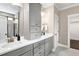 Bathroom with double sinks, white quartz countertops, gray cabinets, and a closet on the side wall at 1119 Brookfield Dr, Gibsonville, NC 27249