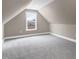 Bedroom under eaves with neutral colored walls and carpeting and a window overlooking the yard at 1119 Brookfield Dr, Gibsonville, NC 27249