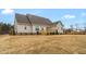 Home exterior, showcasing a well-maintained lawn and a charming wooden deck, ideal for outdoor entertaining and relaxation at 1119 Brookfield Dr, Gibsonville, NC 27249