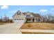 Well-maintained home featuring a covered porch and a two-car garage at 1119 Brookfield Dr, Gibsonville, NC 27249