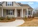 Inviting front porch with classic columns and a charming entryway at 1119 Brookfield Dr, Gibsonville, NC 27249