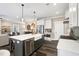 Open kitchen area with stainless steel appliances, a breakfast bar, and hardwood flooring at 1119 Brookfield Dr, Gibsonville, NC 27249