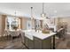 Spacious kitchen featuring a farmhouse sink, eat-in island and open to the dining and living areas at 1119 Brookfield Dr, Gibsonville, NC 27249
