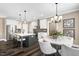 Bright kitchen features an island with seating, stainless steel appliances, and modern lighting at 1119 Brookfield Dr, Gibsonville, NC 27249