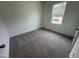 Bright bedroom with neutral carpet and a window showcasing the outdoor view at 11198 Salers Loop, Middlesex, NC 27557