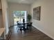 Cozy dining area featuring hardwood floors and natural light from the sliding glass doors at 11198 Salers Loop, Middlesex, NC 27557