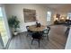 Bright dining area featuring a stylish table set, hardwood floors and large windows at 11198 Salers Loop, Middlesex, NC 27557