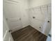 Functional laundry room with vinyl flooring, wire shelving and hookups at 11198 Salers Loop, Middlesex, NC 27557