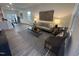 Open-concept living room featuring modern furnishings, neutral decor, and hardwood floors at 11198 Salers Loop, Middlesex, NC 27557