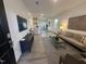 Inviting living room with hardwood floors, seamlessly connecting to an adjacent kitchen and dining area at 11198 Salers Loop, Middlesex, NC 27557