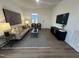 Cozy living room featuring hardwood flooring, contemporary decor, and neutral colored furniture at 11198 Salers Loop, Middlesex, NC 27557