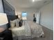 Spacious main bedroom features soft carpet, neutral decor, and an abundance of natural light at 11198 Salers Loop, Middlesex, NC 27557