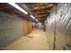 Unfinished basement with exposed wood rafters, concrete block walls, and some areas wrapped in foil insulation at 116 Trinity Woods Dr, Raleigh, NC 27607