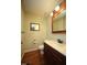 Well-lit bathroom with vanity, mirror, toilet, and hardwood flooring at 116 Trinity Woods Dr, Raleigh, NC 27607