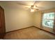 Neutral bedroom with light-filled window, neutral carpet, and overhead ceiling fan at 116 Trinity Woods Dr, Raleigh, NC 27607