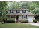 Charming two-story home with a well-manicured lawn and cozy front porch at 116 Trinity Woods Dr, Raleigh, NC 27607