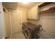 Laundry room features modern washer and dryer units, storage cabinets, and a utility sink at 116 Trinity Woods Dr, Raleigh, NC 27607