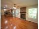 Open-concept living room and kitchen area showcasing hardwood floors and a stone fireplace at 116 Trinity Woods Dr, Raleigh, NC 27607