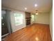 Bright living room featuring a stone fireplace, hardwood floors, and sliding glass doors to the outside at 116 Trinity Woods Dr, Raleigh, NC 27607